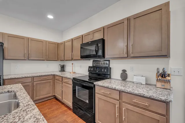 a kitchen with appliances cabinets and a counter top space