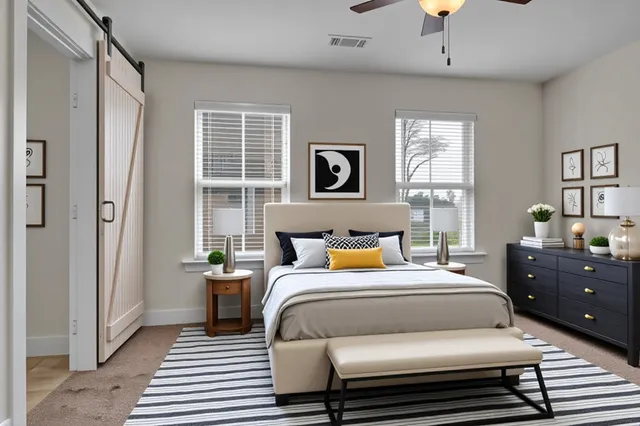 a view of a livingroom with a ceiling fan & entryway