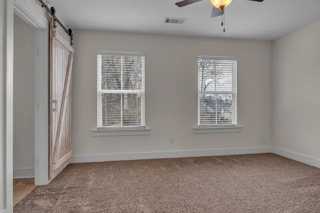 a bathroom with a granite countertop sink a large mirror and a window