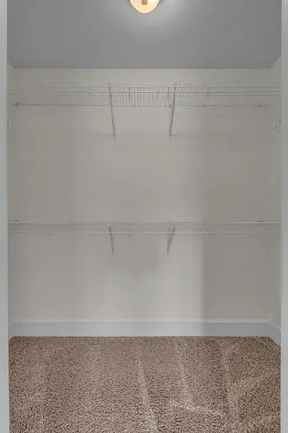 an empty room with closet area