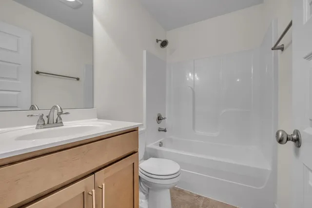 a utility room with cabinets washer and dryer