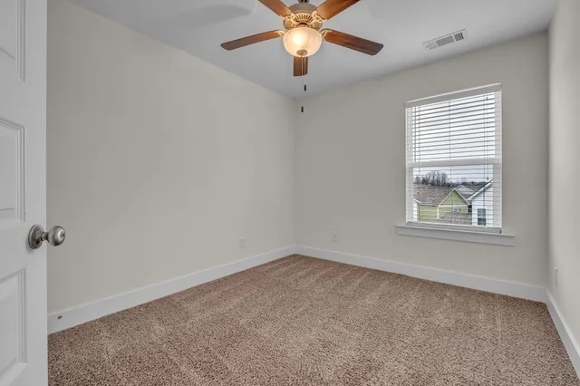 a view of a patio with a table and chairs