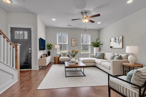 a living room with furniture potted plant and a window