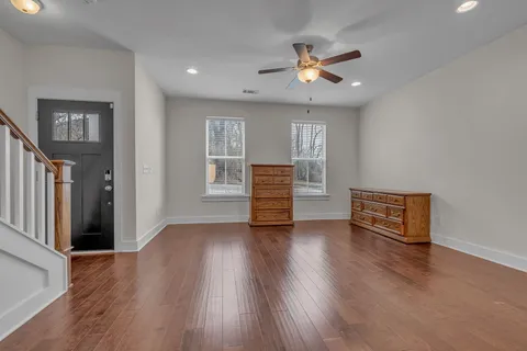 a view of a kitchen with a stove wooden cabinet a kitchen wooden floor and chandelier