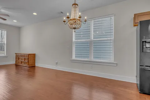 a view of a dining room with furniture and a chandelier