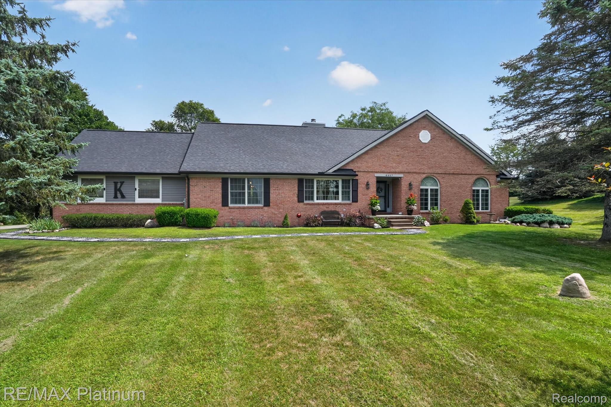 4457 Bradley Road Gregory, MI 48137 - Photo 67 of 79 Brick exterior with a dark shingle roof, featuring a prominent gable and arched windows