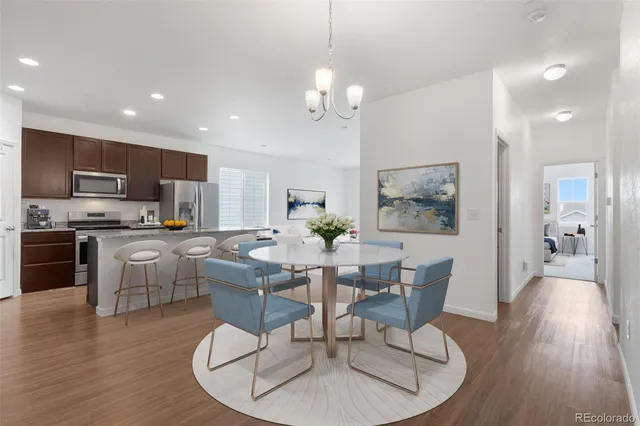 a living room with kitchen island furniture and wooden floor