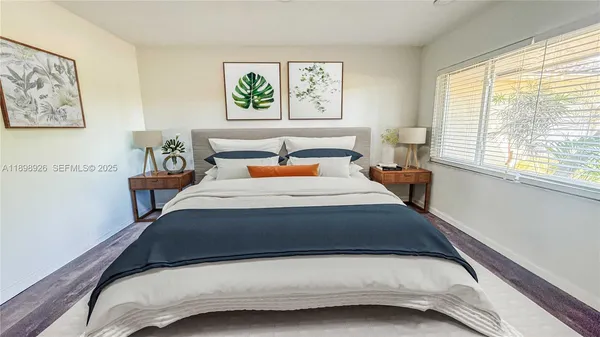 a bedroom with a bed and window