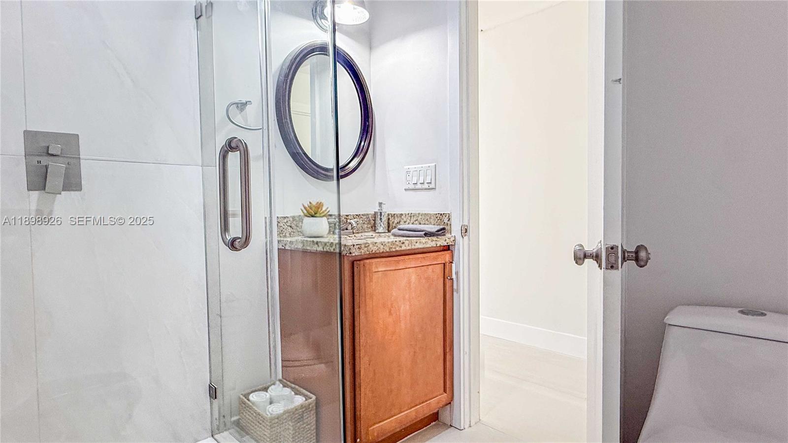 10134 Boca Woods Lane, Unit 10134 Boca Raton, FL 33428 - Photo 9 of 17 a bathroom with a sink and a mirror
