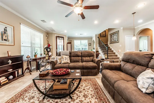 a living room with furniture a dining table and a window