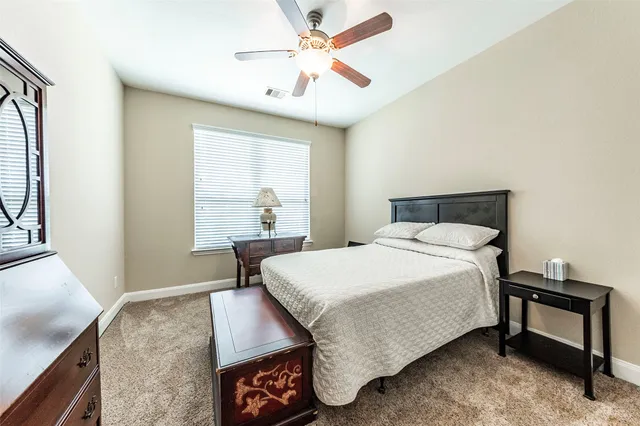 a spacious bedroom with a bed and window