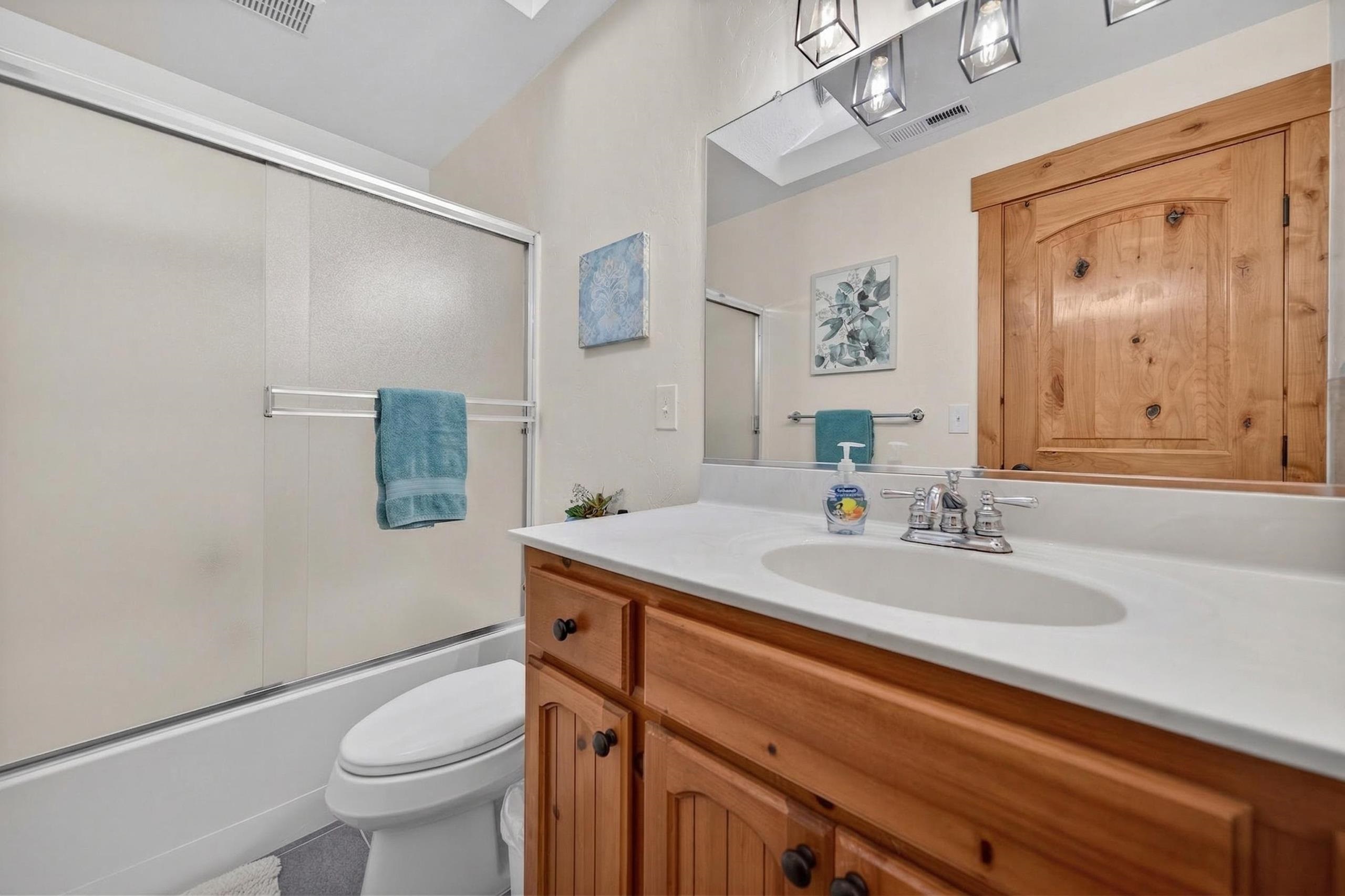 1220 Lynx Road Lake Almanor, CA 96137 - Photo 21 of 45 a bathroom with a sink a toilet a mirror and vanity