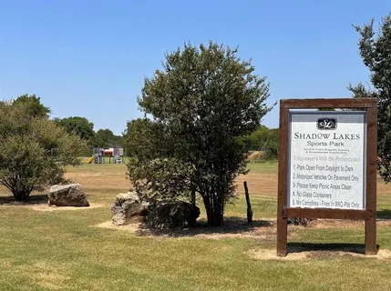 a swimming pool with trees in the background