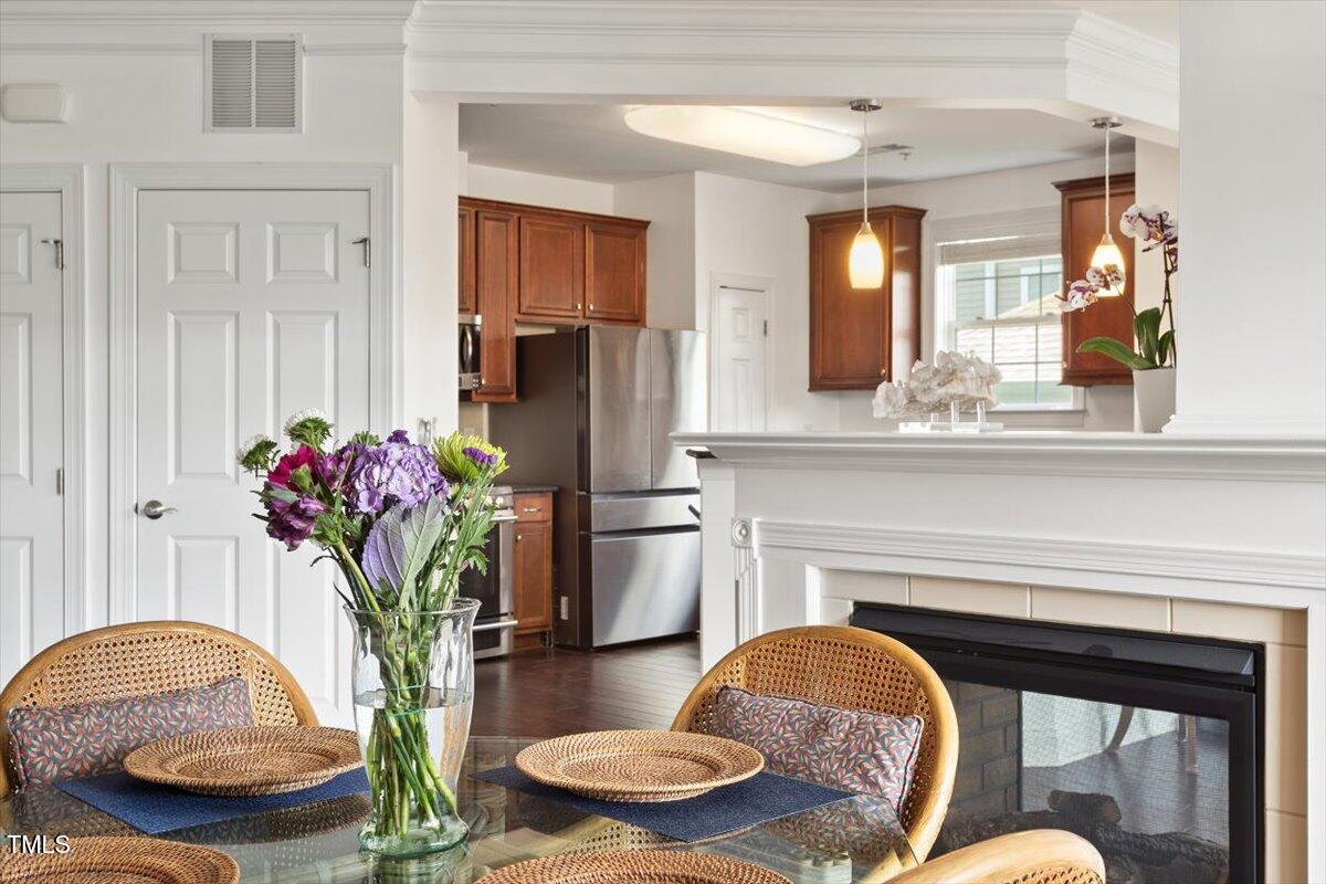 10511 Rosegate Court, Unit 103 Raleigh, NC 27617 - Photo 19 of 56 Dining area features double sided fireplace