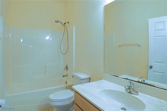 a bathroom with a sink toilet vanity and shower