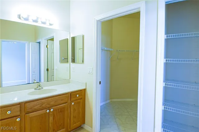 a bathroom with a double vanity sink and a mirror