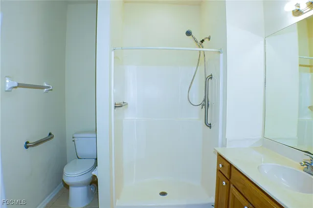 a bathroom with a granite countertop toilet sink and shower