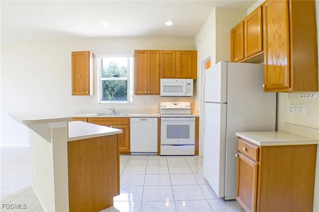 a kitchen with a refrigerator a stove top oven a washer and dryer