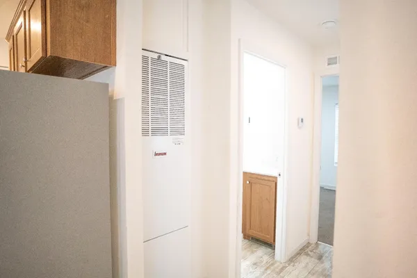 a white refrigerator freezer and a stove sitting inside of a kitchen
