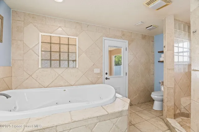 a bathroom with a bathtub and toilet