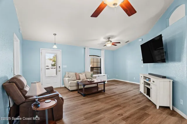 a living room with furniture and a flat screen tv