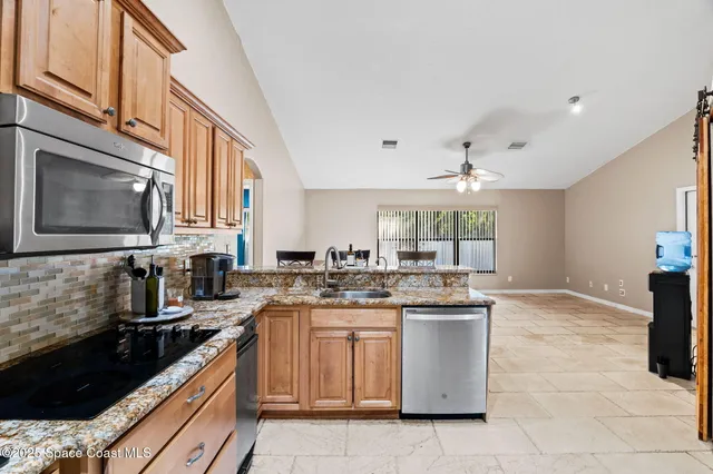 a kitchen with a sink stove and cabinets