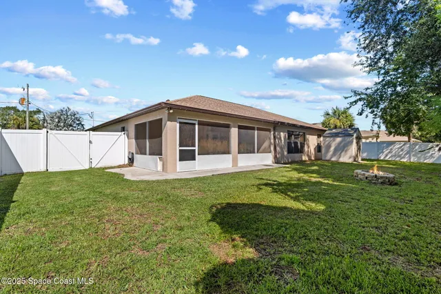 a view of a house with yard and sitting area