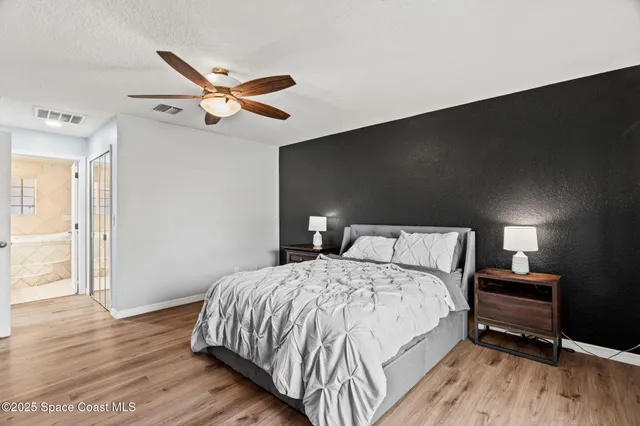 a bedroom with a bed and a night stand