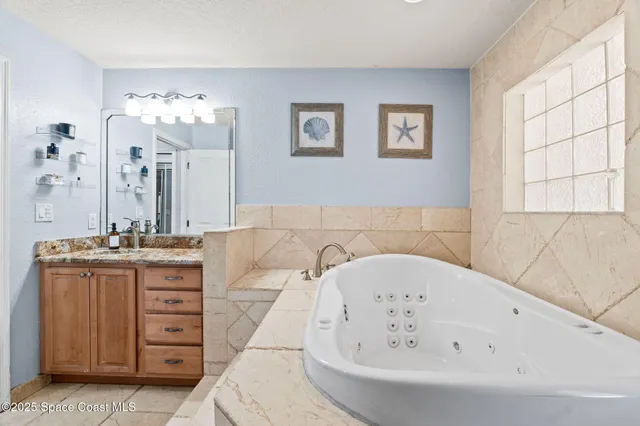 a bathroom with a tub sink and mirror