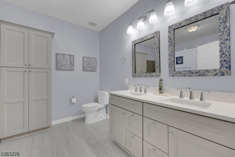 7 Ridgeview Lane, Unit 7 Mount Arlington, NJ 07856 - Photo 15 of 33 a bathroom with a toilet a sink and mirror