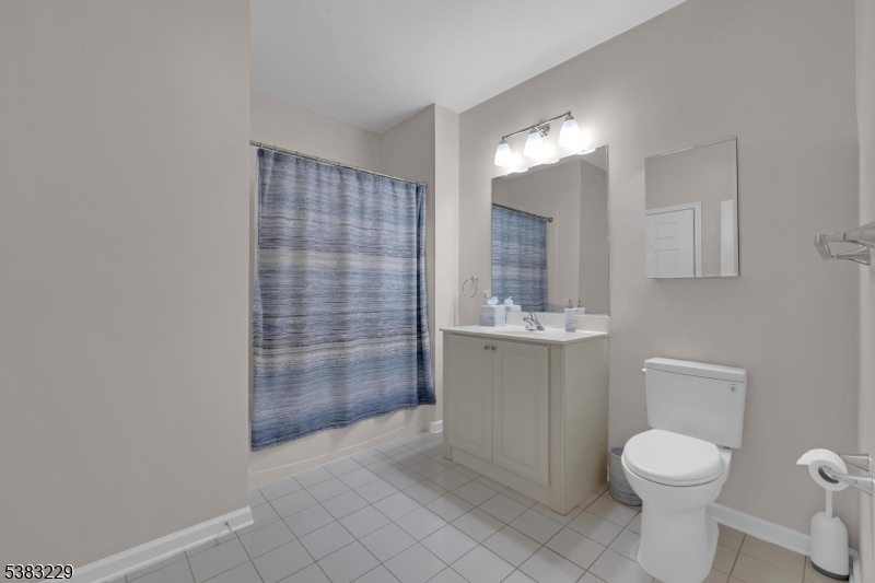 7 Ridgeview Lane, Unit 7 Mount Arlington, NJ 07856 - Photo 17 of 33 a bathroom with a toilet a sink and mirror