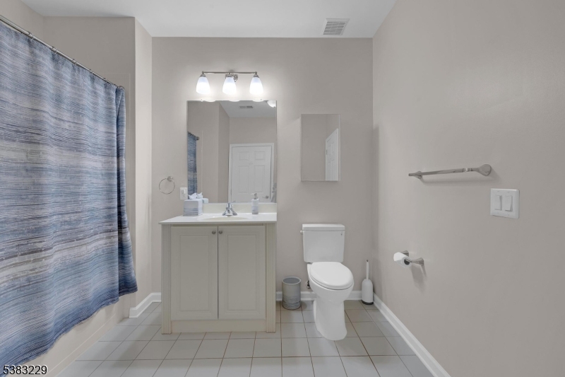 7 Ridgeview Lane, Unit 7 Mount Arlington, NJ 07856 - Photo 19 of 33 a bathroom with a toilet a sink and mirror