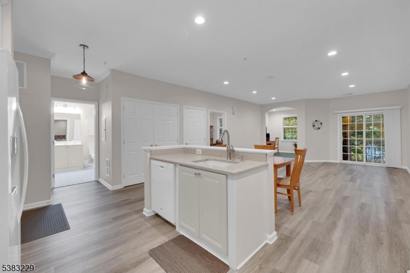 7 Ridgeview Lane, Unit 7 Mount Arlington, NJ 07856 - Photo 5 of 33 a kitchen with stainless steel appliances granite countertop a white refrigerator a sink dishwasher and a oven with wooden floor