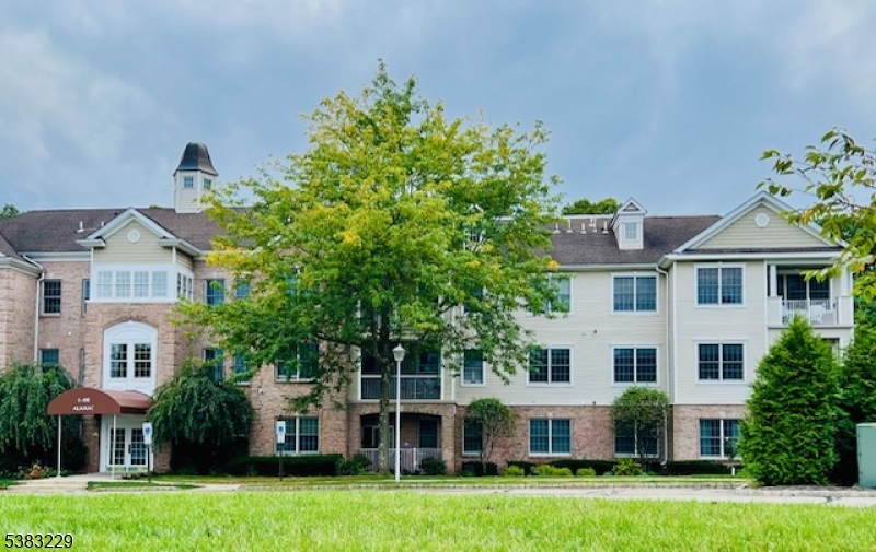 7 Ridgeview Lane, Unit 7 Mount Arlington, NJ 07856 - Photo 6 of 33 a view of a white house with a big yard and potted plants and large trees