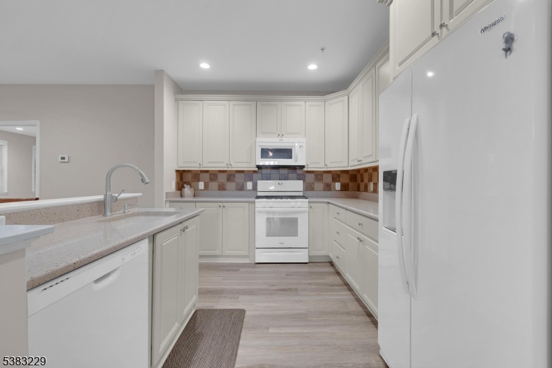 7 Ridgeview Lane, Unit 7 Mount Arlington, NJ 07856 - Photo 7 of 33 a kitchen with granite countertop white cabinets and white appliances