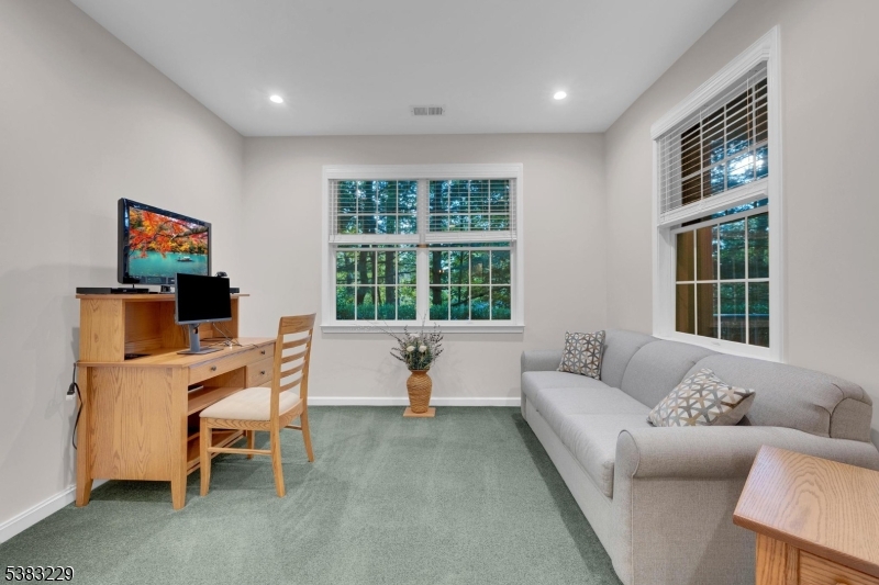 7 Ridgeview Lane, Unit 7 Mount Arlington, NJ 07856 - Photo 9 of 33 a living room with furniture and a flat screen tv