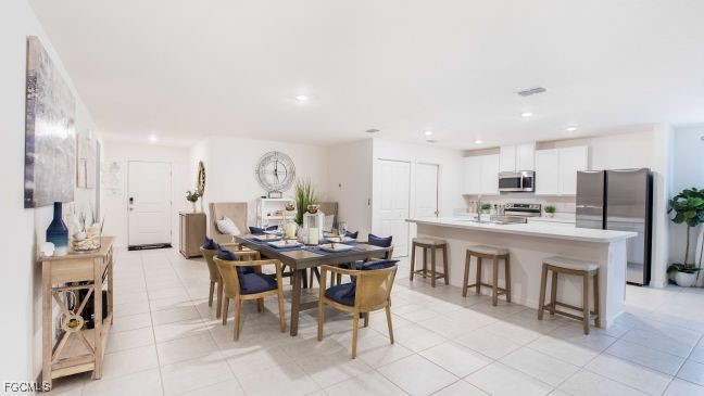 3715 32nd Street Southwest Lehigh Acres, FL 33976 - Photo 4 of 19 a view of a dining room with furniture