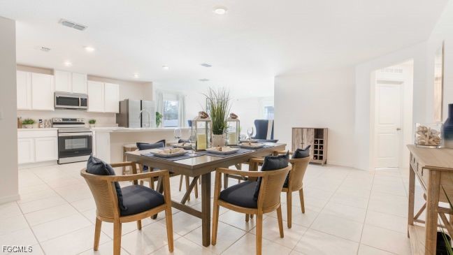 3715 32nd Street Southwest Lehigh Acres, FL 33976 - Photo 6 of 19 a kitchen with a table and chairs in it