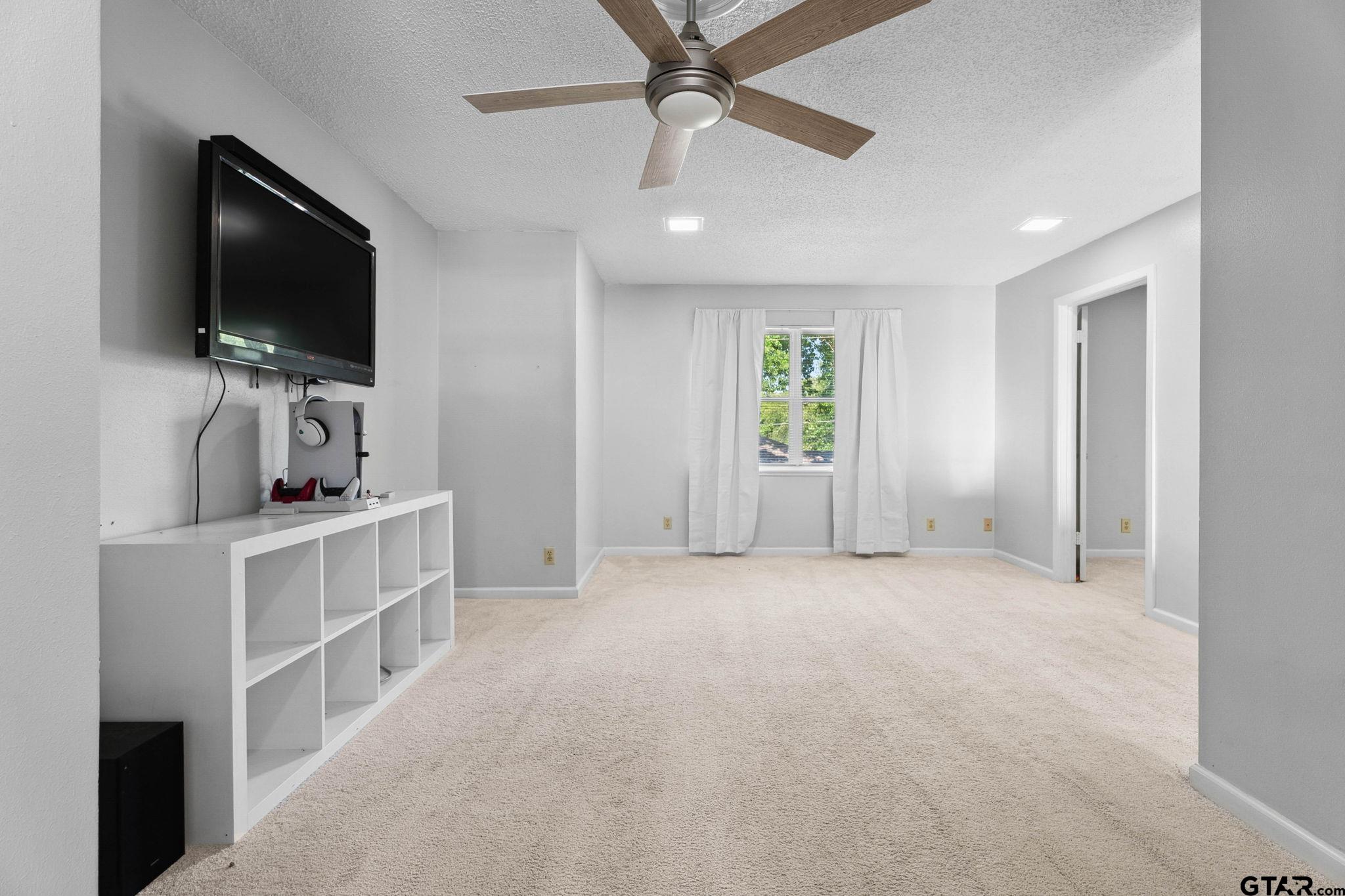 8224 Purdue Drive Tyler, TX 75703 - Photo 14 of 39 a view of living room with flat screen tv and windows