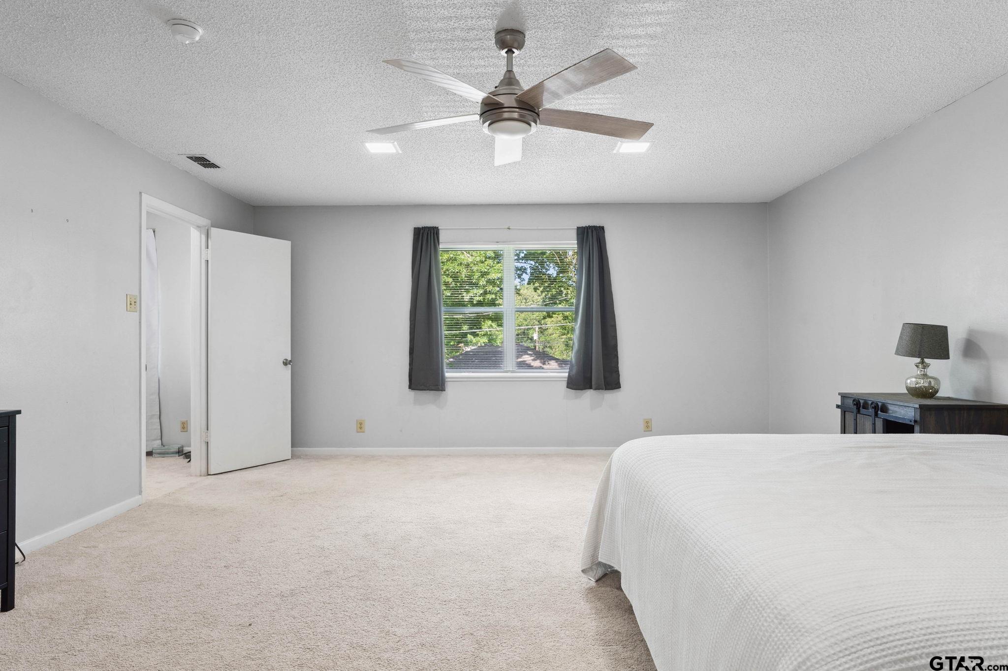 8224 Purdue Drive Tyler, TX 75703 - Photo 18 of 39 a bedroom with a bed and a window