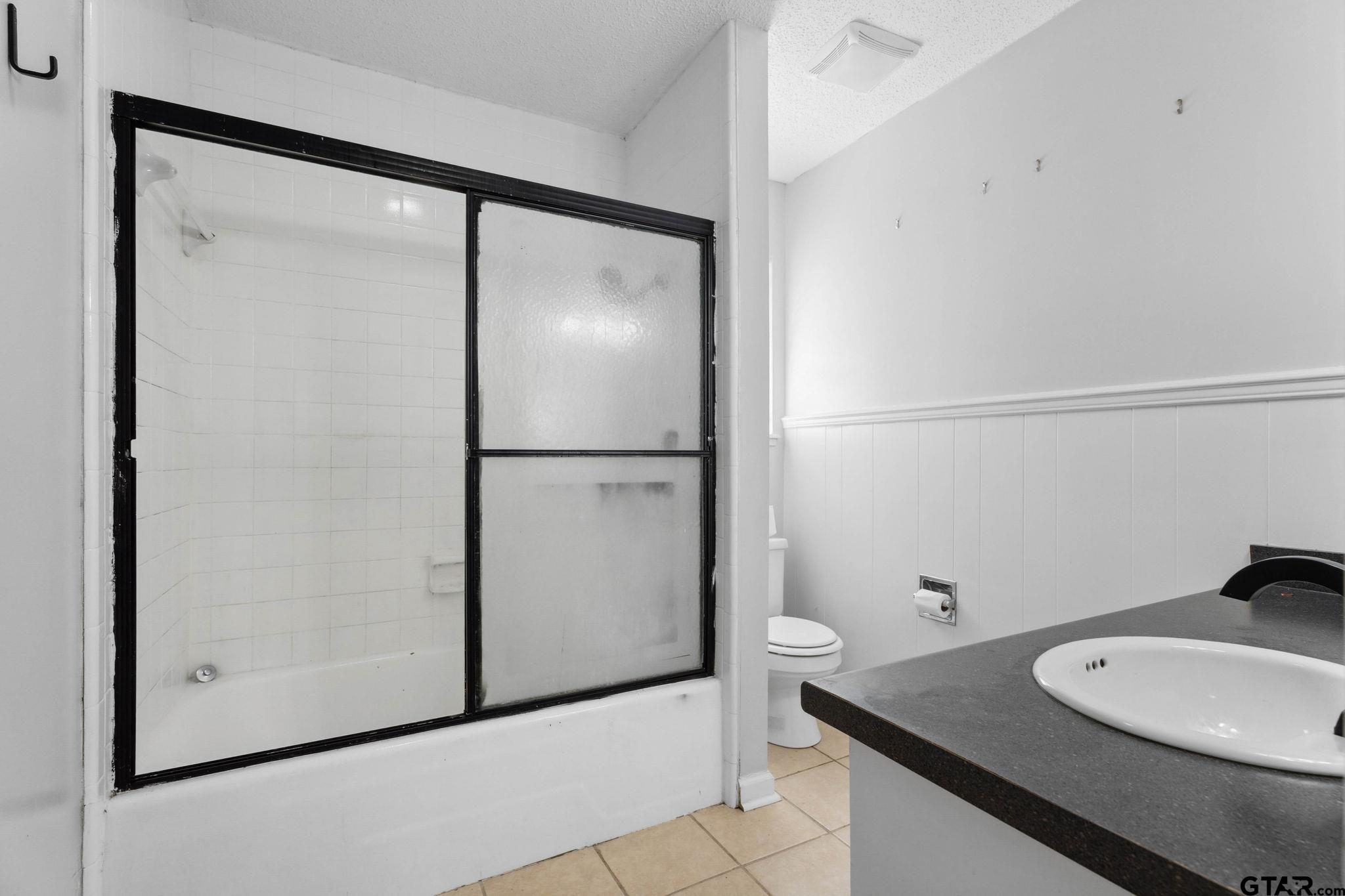 8224 Purdue Drive Tyler, TX 75703 - Photo 20 of 39 a bathroom with a sink mirror vanity and toilet