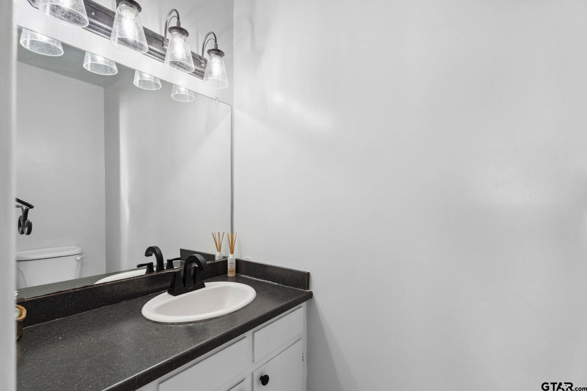 8224 Purdue Drive Tyler, TX 75703 - Photo 22 of 39 a bathroom with a sink and a mirror