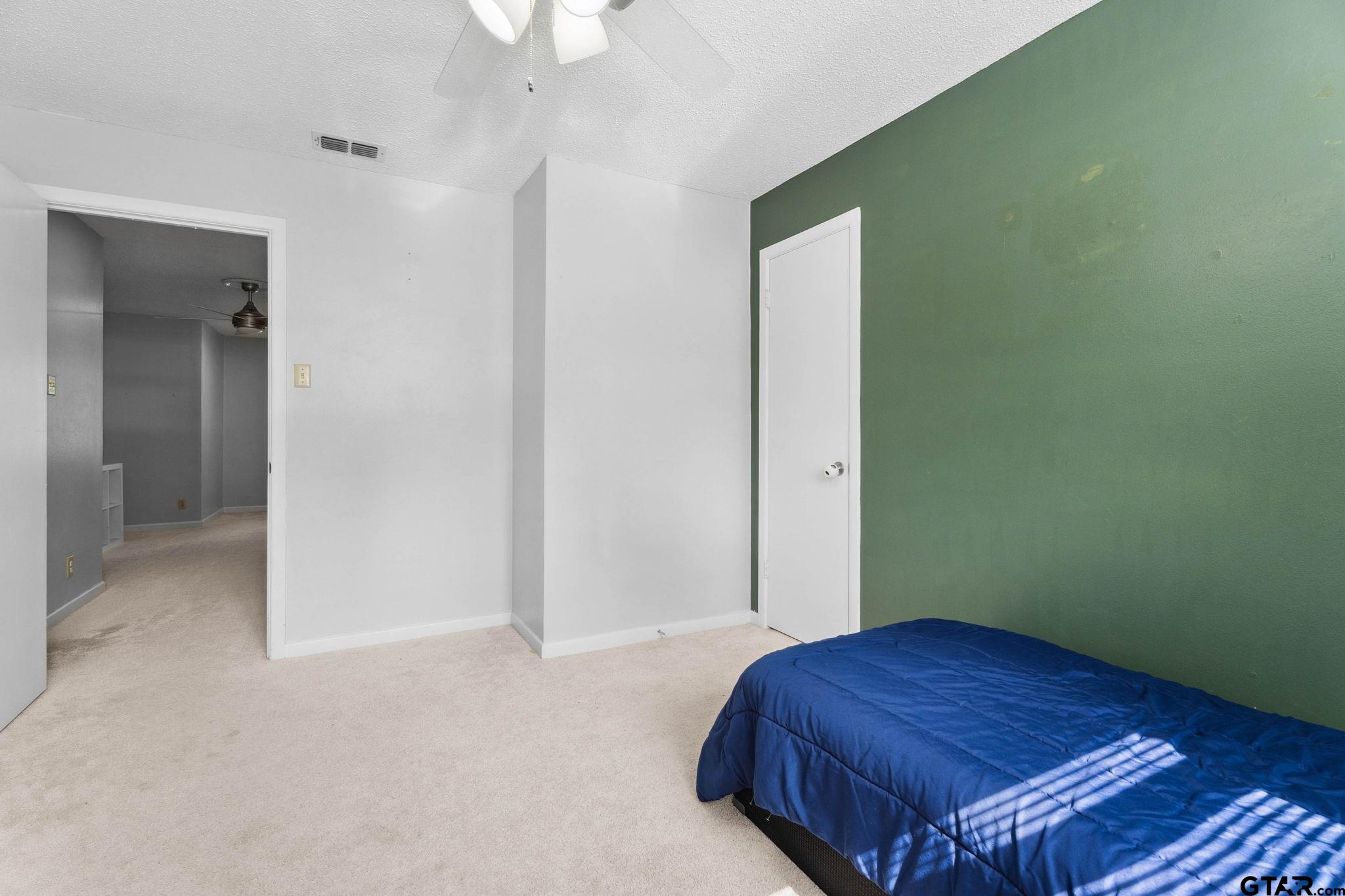 8224 Purdue Drive Tyler, TX 75703 - Photo 30 of 39 a bedroom with a bed and a dresser