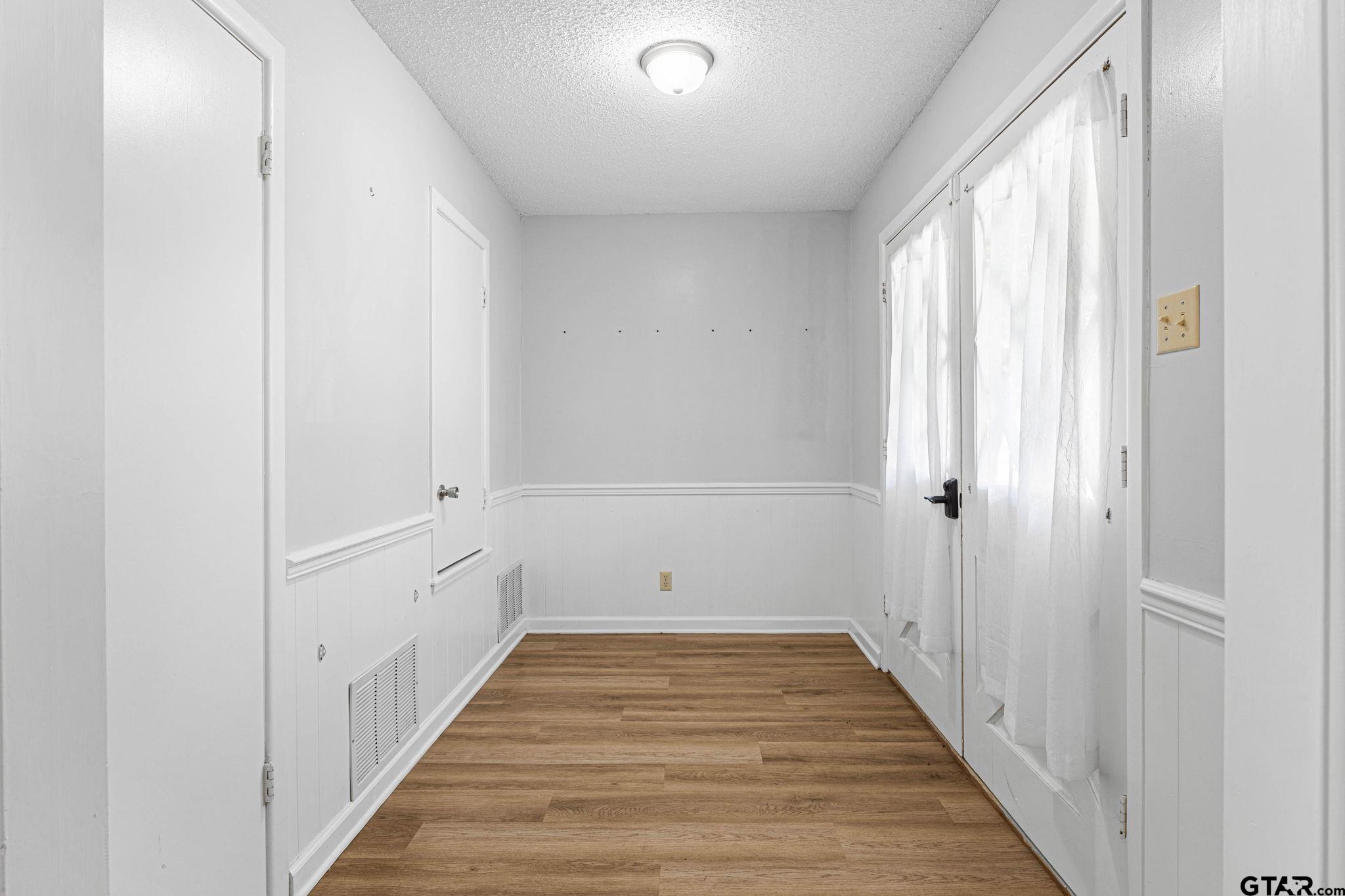 8224 Purdue Drive Tyler, TX 75703 - Photo 3 of 39 a view of a room with wooden floor and windows