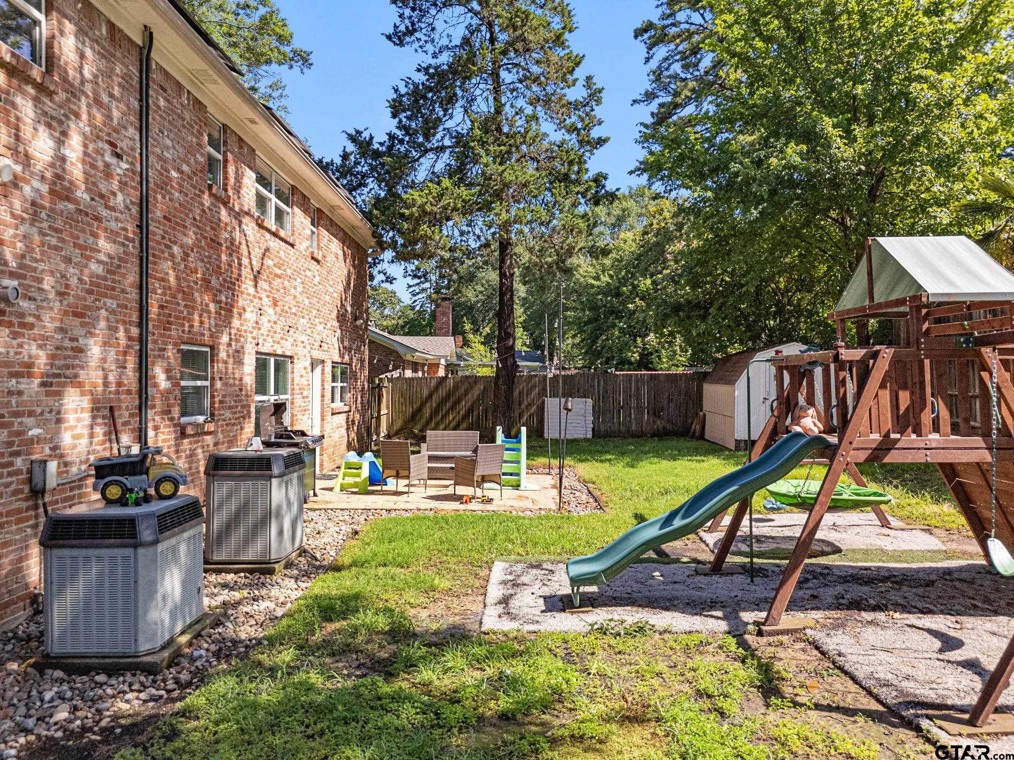 8224 Purdue Drive Tyler, TX 75703 - Photo 34 of 39 a view of a backyard with a table and chairs