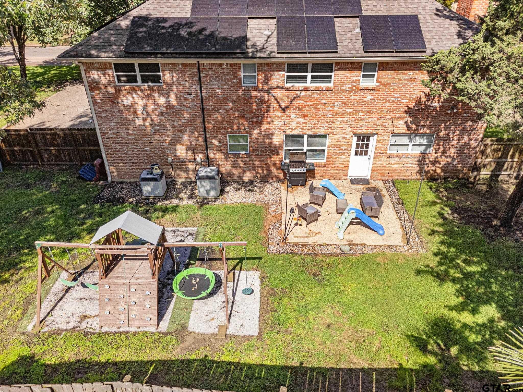 8224 Purdue Drive Tyler, TX 75703 - Photo 38 of 39 an aerial view of a house with swimming pool and large trees