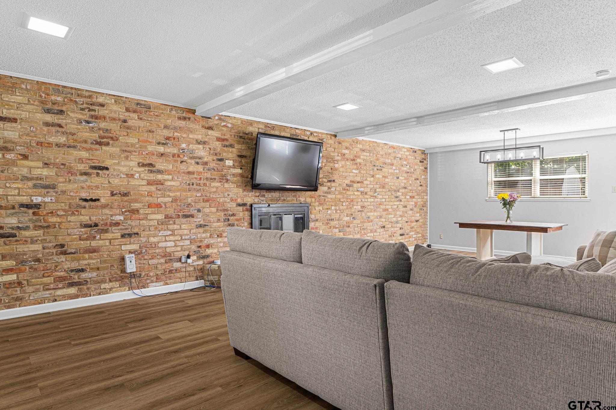 8224 Purdue Drive Tyler, TX 75703 - Photo 4 of 39 a living room with couches bookshelf and a flat screen tv