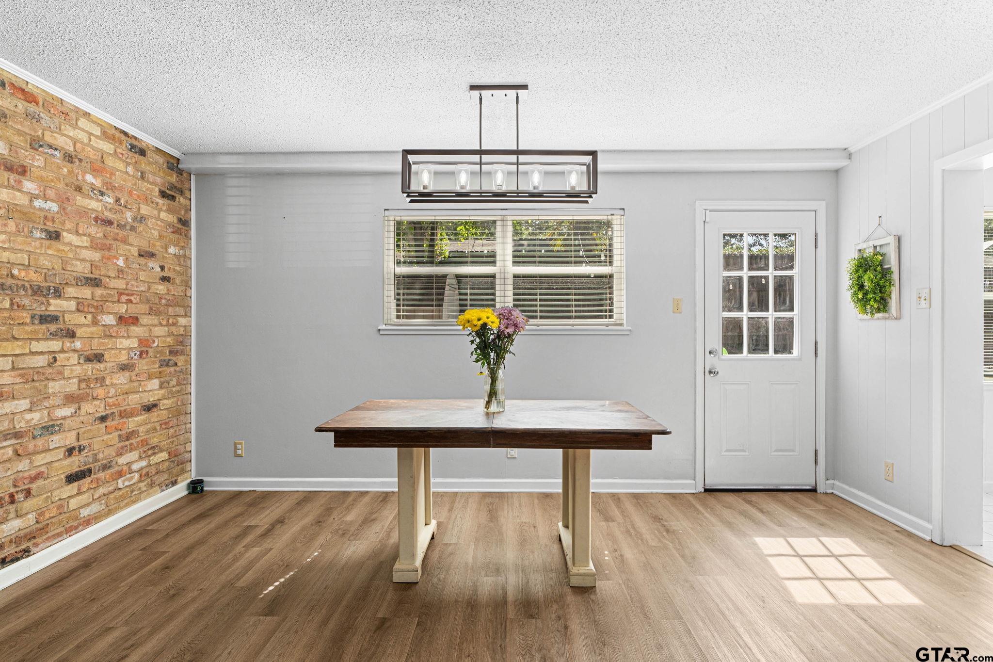 8224 Purdue Drive Tyler, TX 75703 - Photo 8 of 39 a view of a room with wooden floor table and chairs