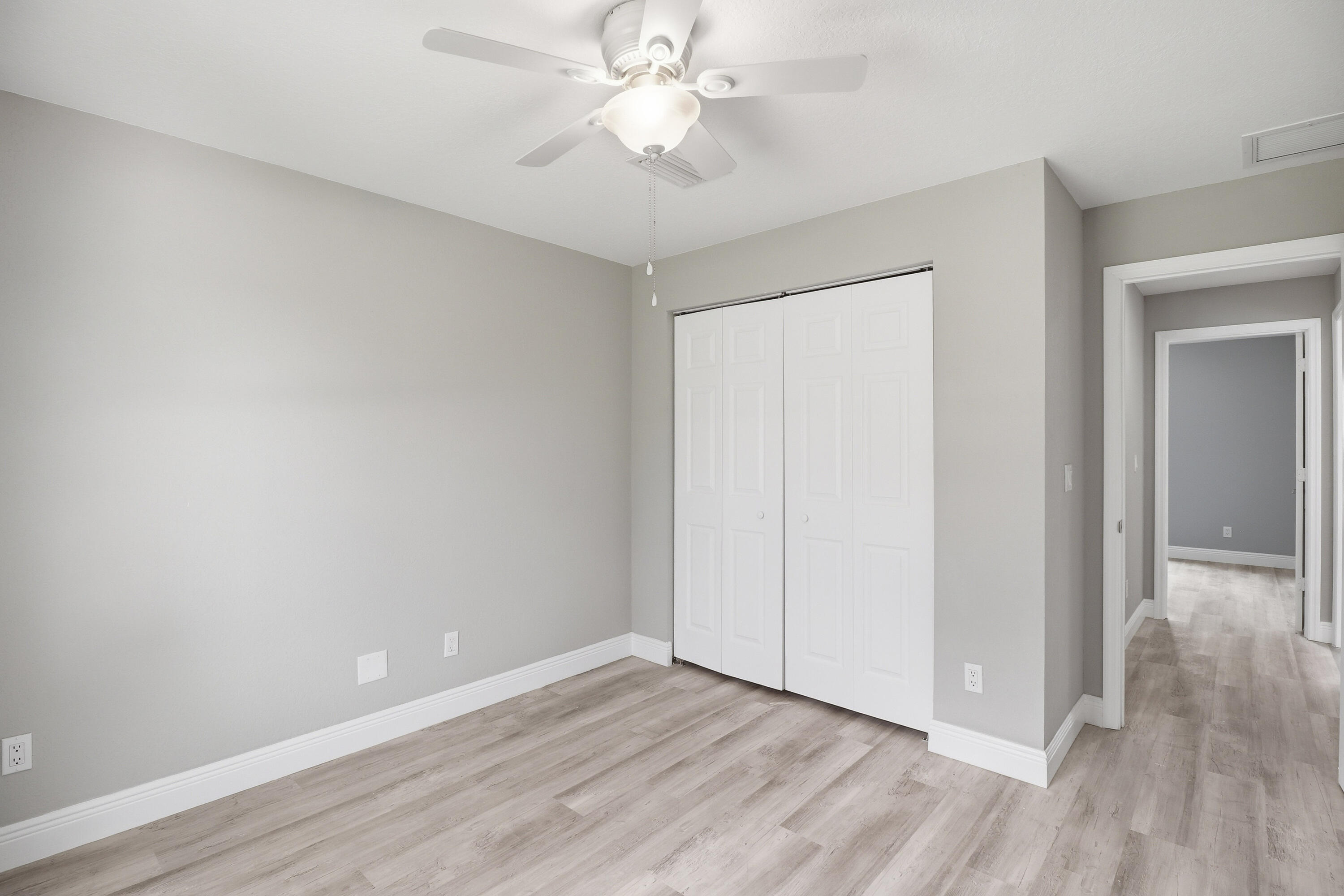 2805 Southeast Carroll Street Stuart, FL 34997 - Photo 15 of 21 a view of an empty room with wooden floor