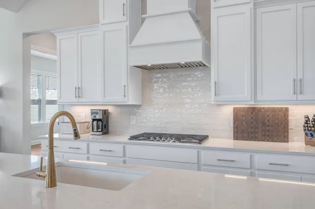 a kitchen with a sink stove and refrigerator